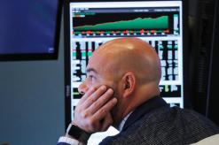 Wall Street slides, Dow erases 2018 gains as trade spat intensifies