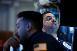 Investors seek cover as trade battles rattle world markets