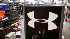 Under Armour earnings, sales top expectations. And the stock is swinging all over the place