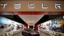 Tesla shares rise after company reverses decision to close all stores