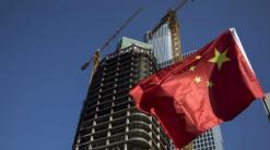 China's economy picks up as companies pile on debt, survey finds