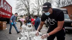 Grammy-winning artist Lecrae distributes wash stations