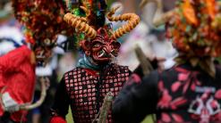 Devils dance, observe virus protocols at Ecuador festival