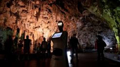 Persephone, the robot guide, leads visitors in a Greek cave