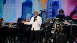 Henri cuts short Manilow set at NYC virus recovery concert