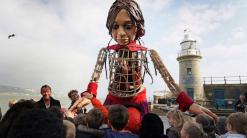 Puppet Little Amal arrives in UK after journey across Europe