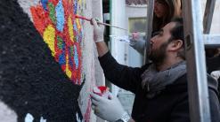 Evacuated Afghan artists paint a mural in Albania's capital