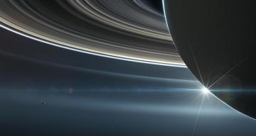 Saturn’s rings paint some of its moons shades of blue and red