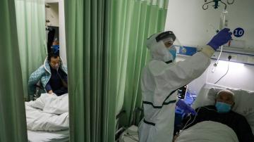 China's virus death toll surpasses SARS but new cases fall