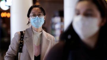 Companies trim outlooks, travel and staff as virus spreads