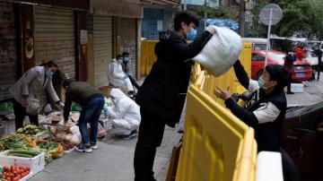 Vendors return in Wuhan as China prepares virus memorial