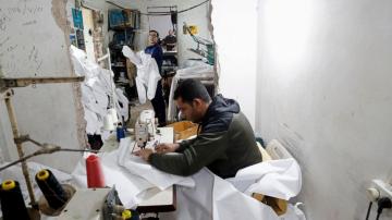 Gaza factories roar back to life to make protective wear