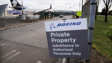 Boeing swings to 1Q loss, announces production cuts