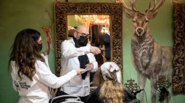 The Latest: German hair salons reopen as virus rules eased