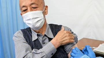 Tokyo adopts tougher virus rules, starts vaccinating elders