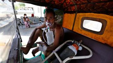 India's crematoriums overwhelmed as virus 'swallows people'