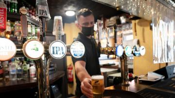 Joy for UK pubs and hugs tempered by rise in virus variant