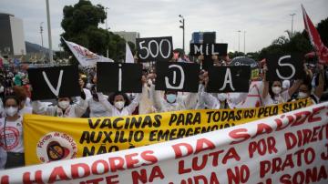 The Latest: Protests decry Brazil policies as toll tops 500K