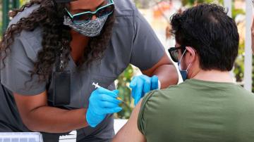 US hitting encouraging milestones on virus deaths and shots