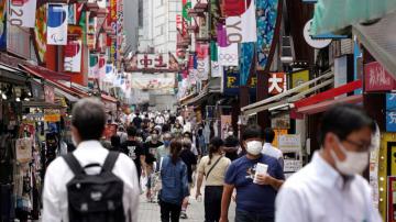 Japan to widen virus emergency after record spike amid Games