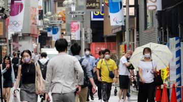 Japan expands virus emergency, weighs legal penalties