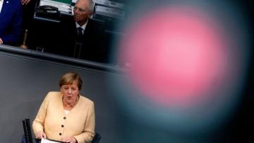 Merkel seeks to boost party before vote, clashes with deputy