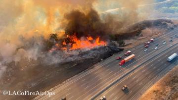 Firefighters advance on blaze that shut California highway