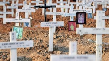 AP PHOTOS: Graveyard mementos in Jakarta mark virus's toll