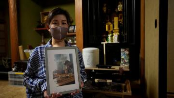 Relatives of virus dead question Japan's stay-at-home policy