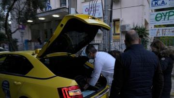 In Greece, taxis help with race to deliver booster shots