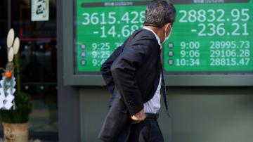 Asian shares mostly slip amid lingering omicron worries