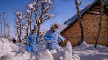 AP PHOTOS: Vaccine workers trek in Kashmir's snowy mountains