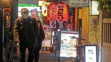 Japan widens virus restrictions as omicron surges in cities