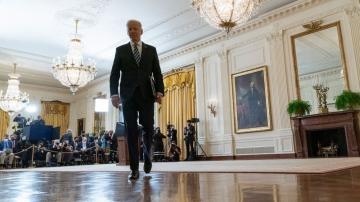 Biden hits Russia with sanctions, shifts troops to Germany