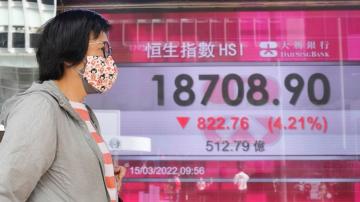 Asian shares mostly lower as crude slides to $100 per barrel