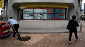 Asian shares fall in thin trading after rout on Wall St