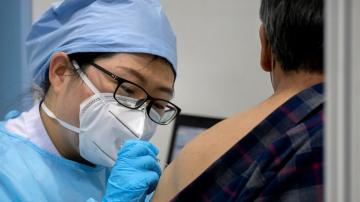 Beijing appears to retract vaccine mandate after pushback
