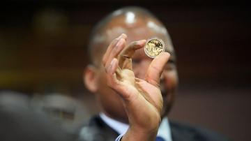 Zimbabwe debuts gold coins as legal tender to stem inflation