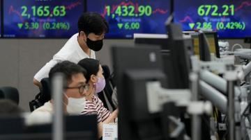 Asian stocks sink on German inflation, British tax cuts
