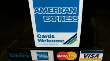 AmEx profits up 3%, but still sets cash aside for downturn