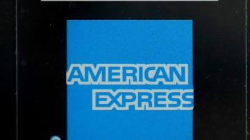 American Express profit rises, but it sets aside more money for possible defaults