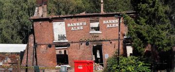 Angry villagers in England call for the quirky Crooked House pub to be rebuilt following demolition