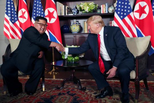 With handshakes, smiles and a thumbs up, Trump and Kim start historic summit