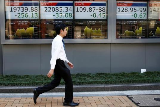 Asian shares slip on Fed hike, trade fears and soft China data