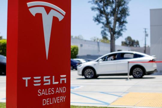 Deal-hungry investment bankers walk Tesla tightrope