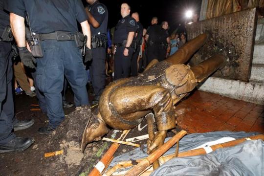 Police accuse three over toppled Confederate statue