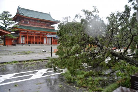 Typhoon kills at least nine in Japan, boats move tourists from flooded airport