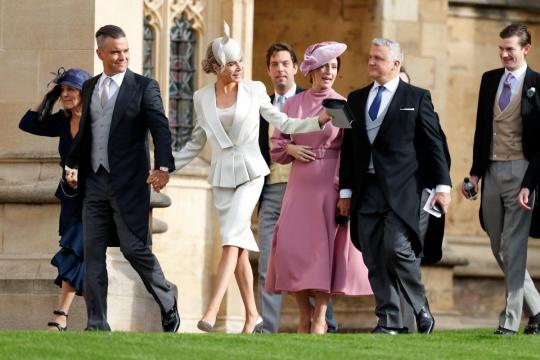 Holding their hats, guests arrive for 2018's second big royal wedding