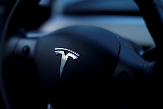 Tesla third-quarter profit quiets critics, shares surge