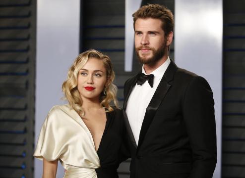 Pop singer Miley Cyrus stands in for husband at film premiere